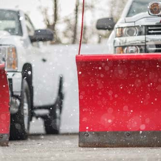white trucks with red plows