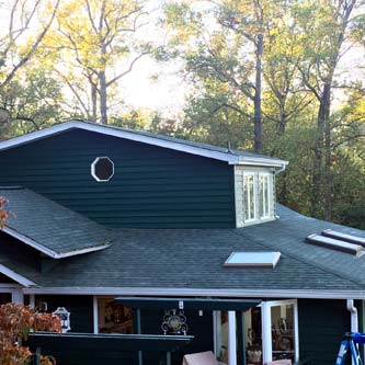 Black house and dark shingle roof.