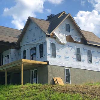 House without siding in current repair
